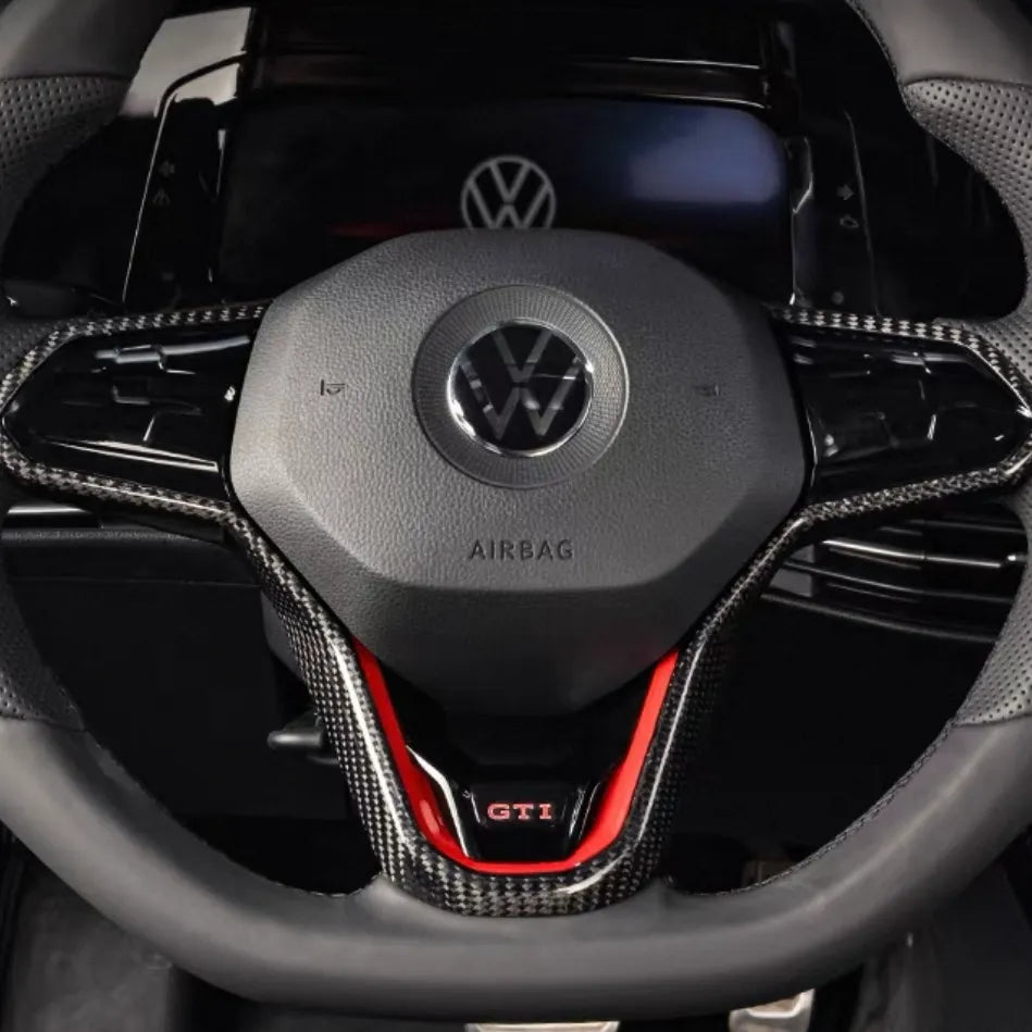 Close-up of VW Golf MK8 GTI and R carbon fiber steering wheel trim in gloss finish, showing high-quality weave and perfect OEM fit.