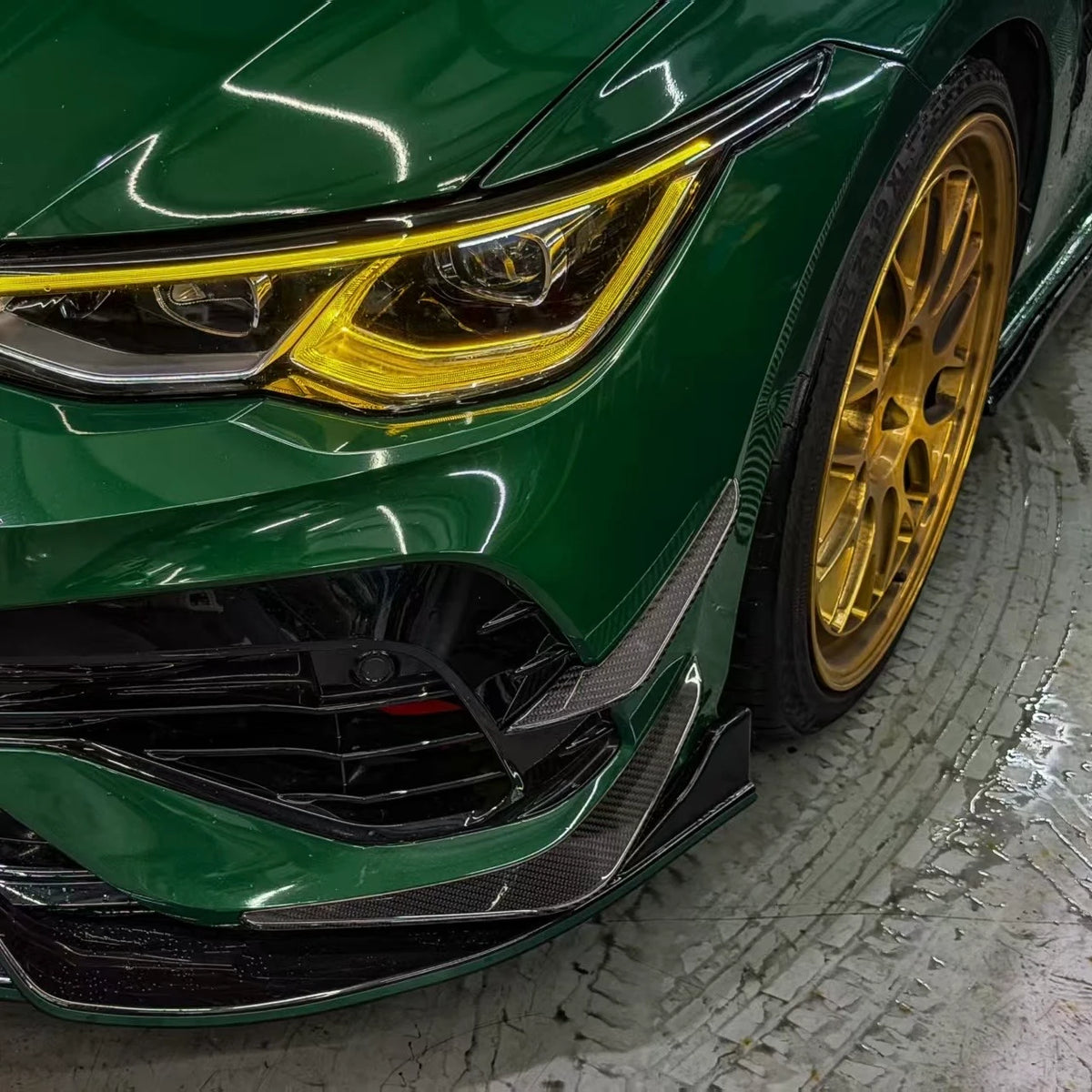 VW Golf MK8 R front bumper canards, close side view — gloss carbon fiber detail