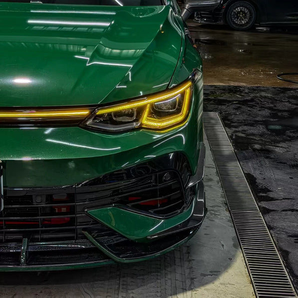 VW Golf MK8 R front bumper canards installed, gloss carbon fiber — driver side view