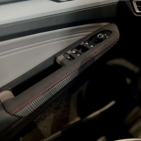 Interior view of a Volkswagen Golf Mk8 GTI featuring a door control panel cover overlay that maintains OEM ergonomics while improving durability and tactile feel.