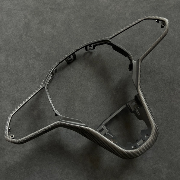 OEM+ carbon fiber steering wheel trim upgrade for VW Golf R MK8.5, designed for precise alignment and compatibility with haptic steering controls.