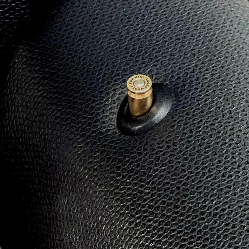 Stylish close-up of the Bullet Door Pin, emphasizing the quality and unique aesthetics of the Anger Work™ Series