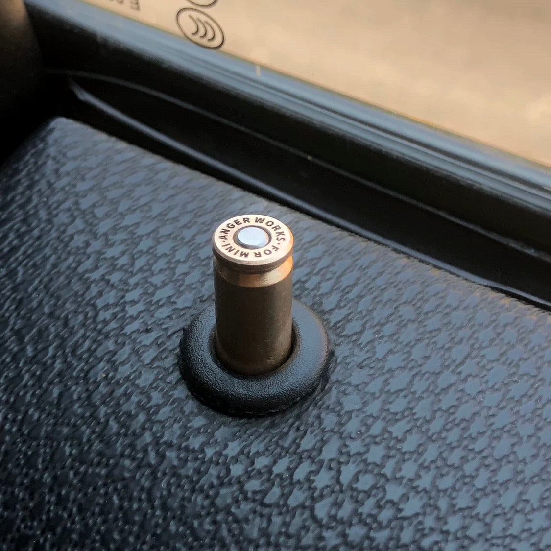 Installed Bullet-Inspired Designer Door Pin in a Mini Cooper F-Series, showcasing its premium brass finish and unique design