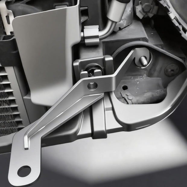 Close-up of custom MINI Cooper fog light bracket installed on left side with 10mm bolt.