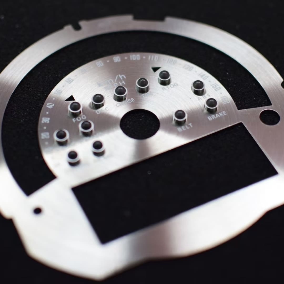 Close-up of MINI Cooper F56 custom CD-laser gauge face cluster with silver finish and green markings.