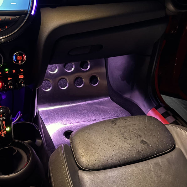 Passenger side metal custom mini cooper parts floor mat installed in MINI Cooper F56 interior, showing fit under floor mats