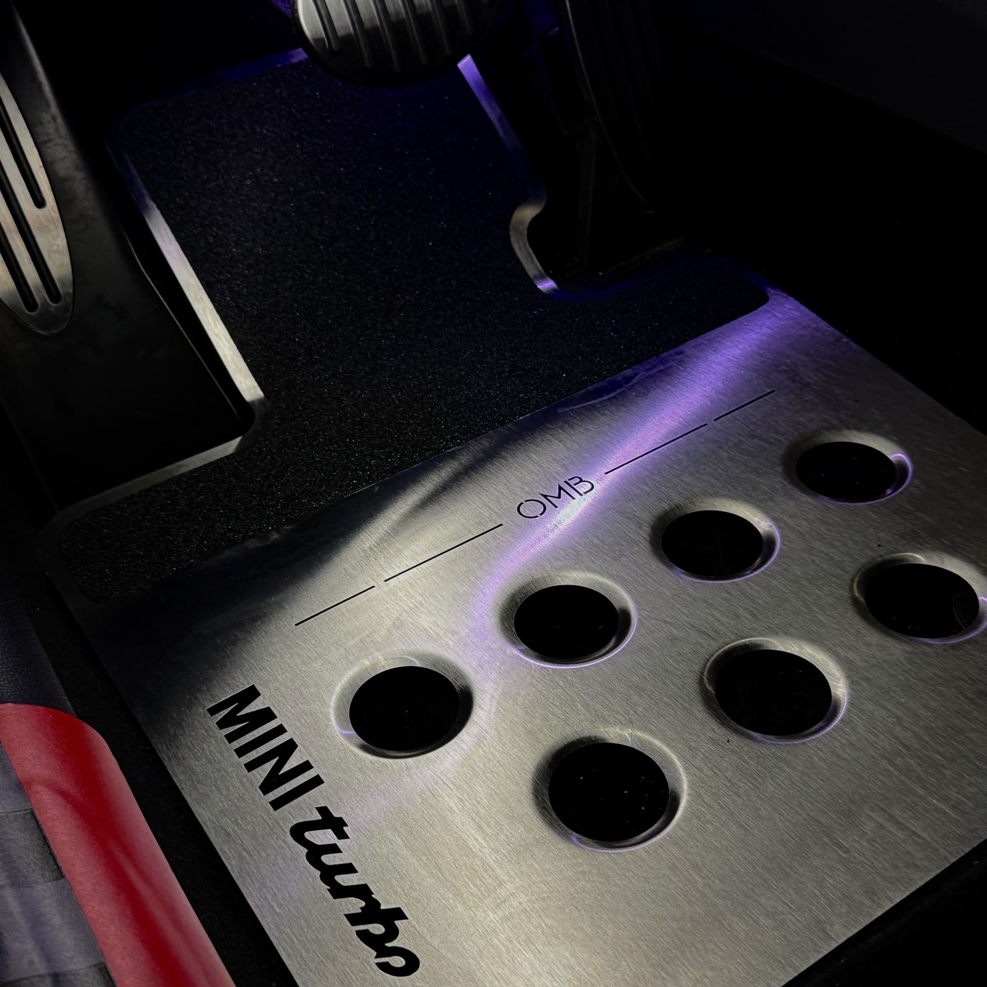 mini cooper aftermarket parts metal floor mat installed on passenger side showing fit over MINI floor contours