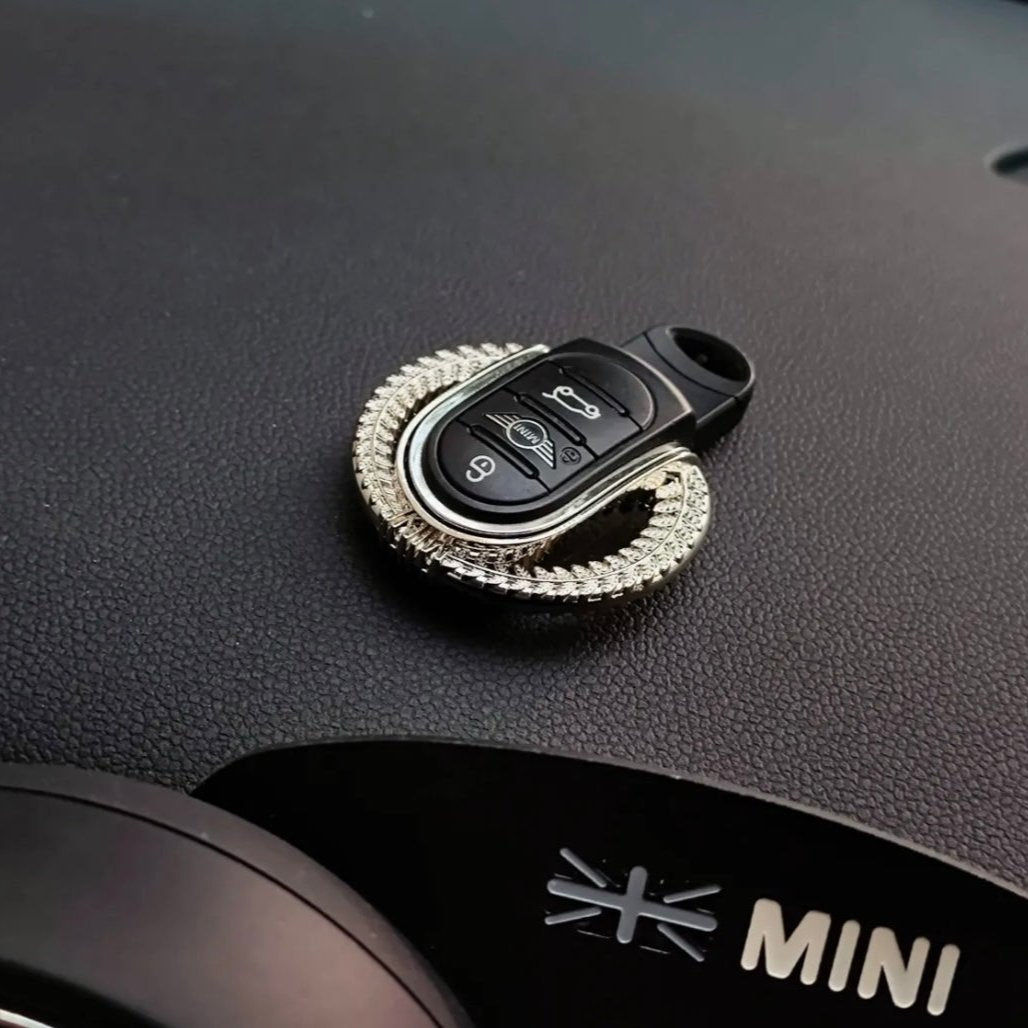 Installed alloy keyfob shell keychain in a Mini Cooper, prominently displaying the unique laurel design and premium craftsmanship