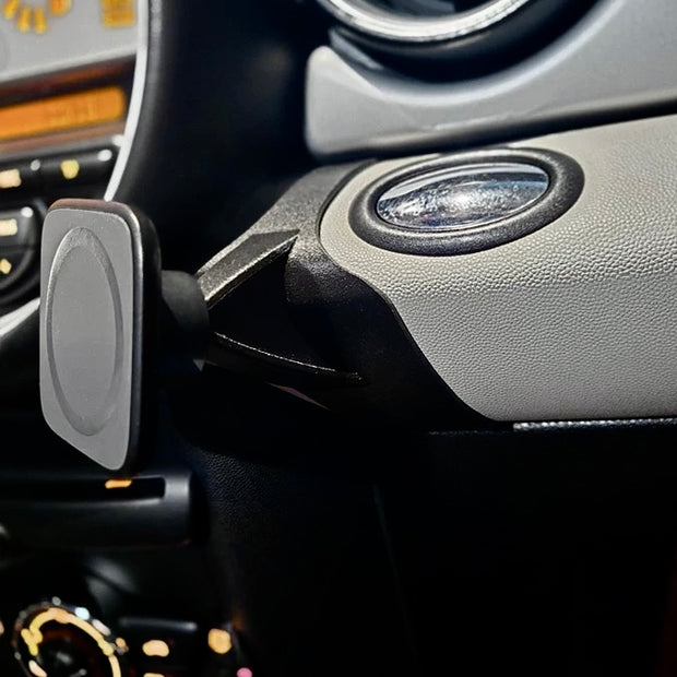 Center-mounted phone holder in MINI Cooper R56 dashboard.