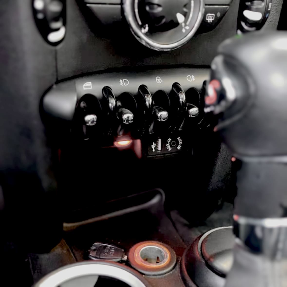 Close-up of installed USB and Bluetooth adaptor in MINI Cooper R-Series dashboard