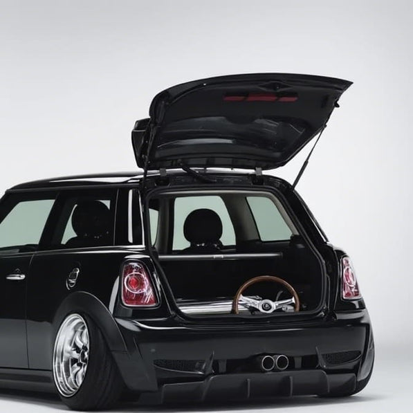 Aftermarket carbon steel rear strut brace installed on MINI Cooper R56, a custom MINI Cooper part enhancing chassis rigidity and handling