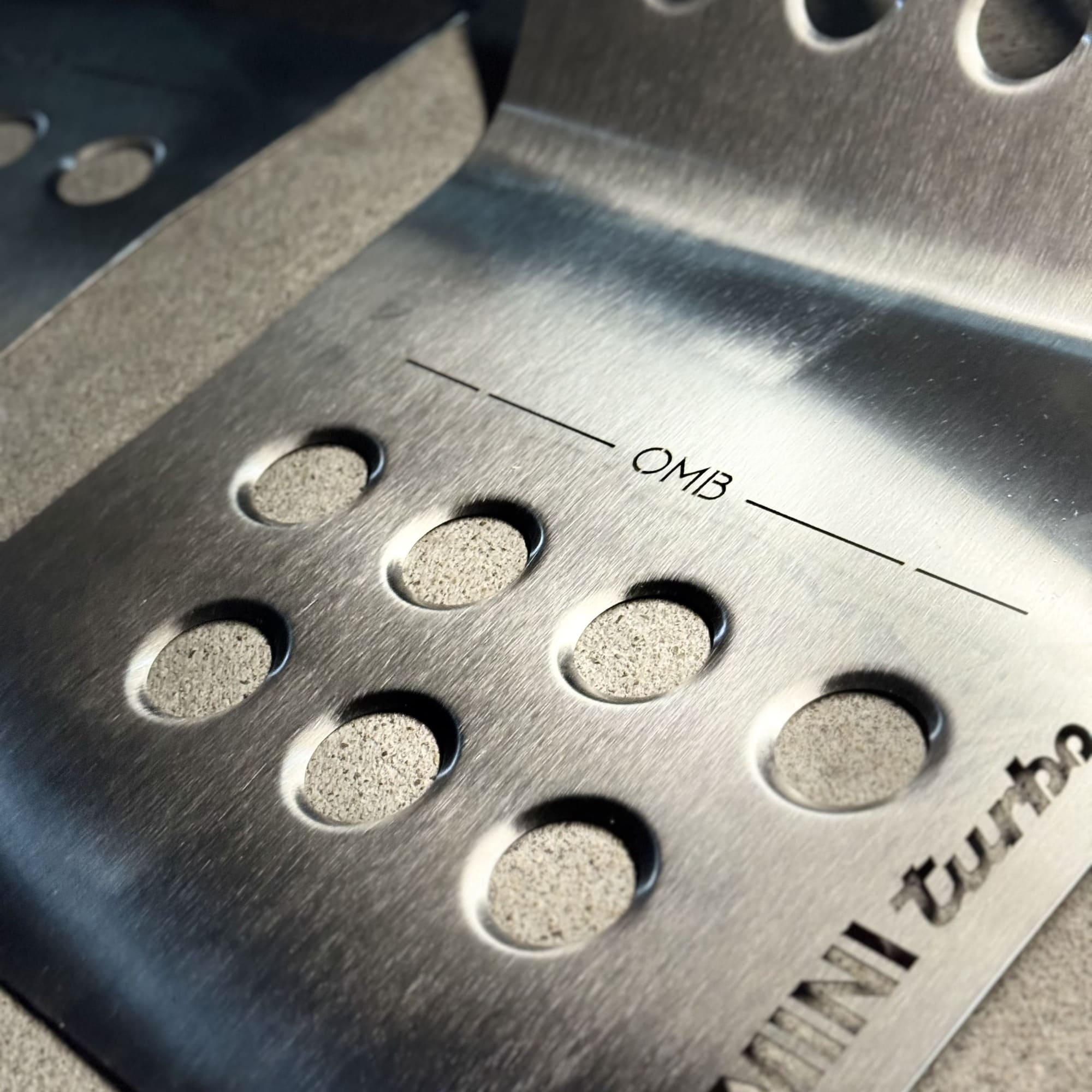 Detail of mini cooper aftermarket parts MINI Cooper R56 metal track mat edge and Velcro attachment for secure fit