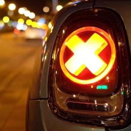 Installed Unique 'X' Designers Tail Light glowing at night in a Mini Cooper, showcasing the striking design