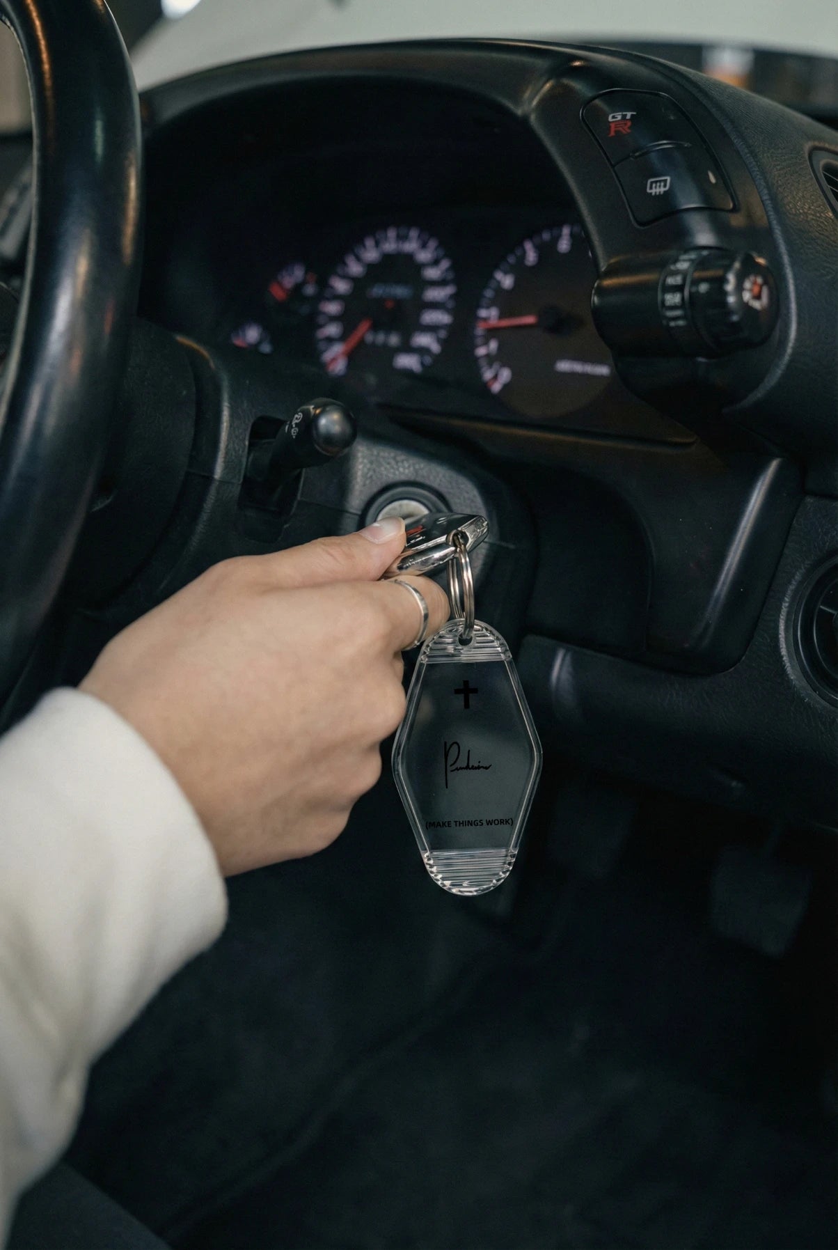 Project P P-02 automotive keychain held in hand vintage motel keyring lifestyle